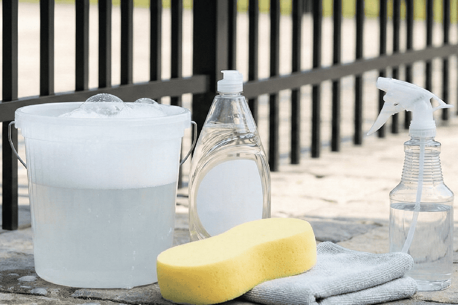 cleaning products in front of fence