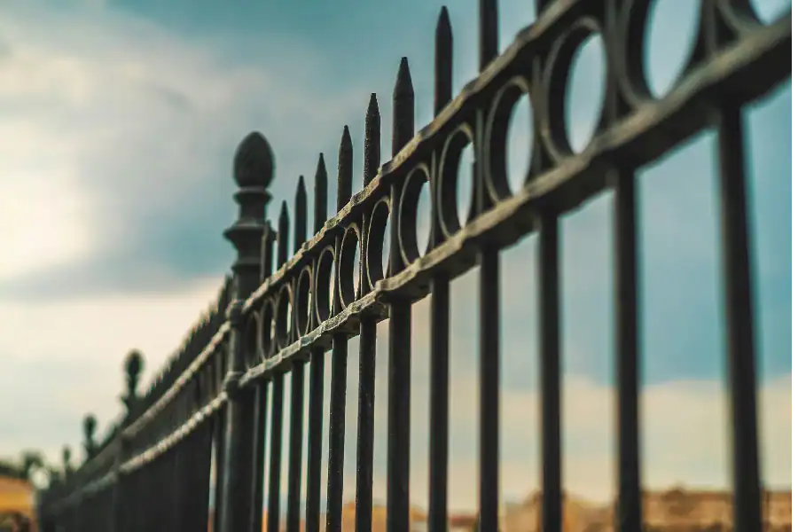 newly painted fence against a blue sky.webp